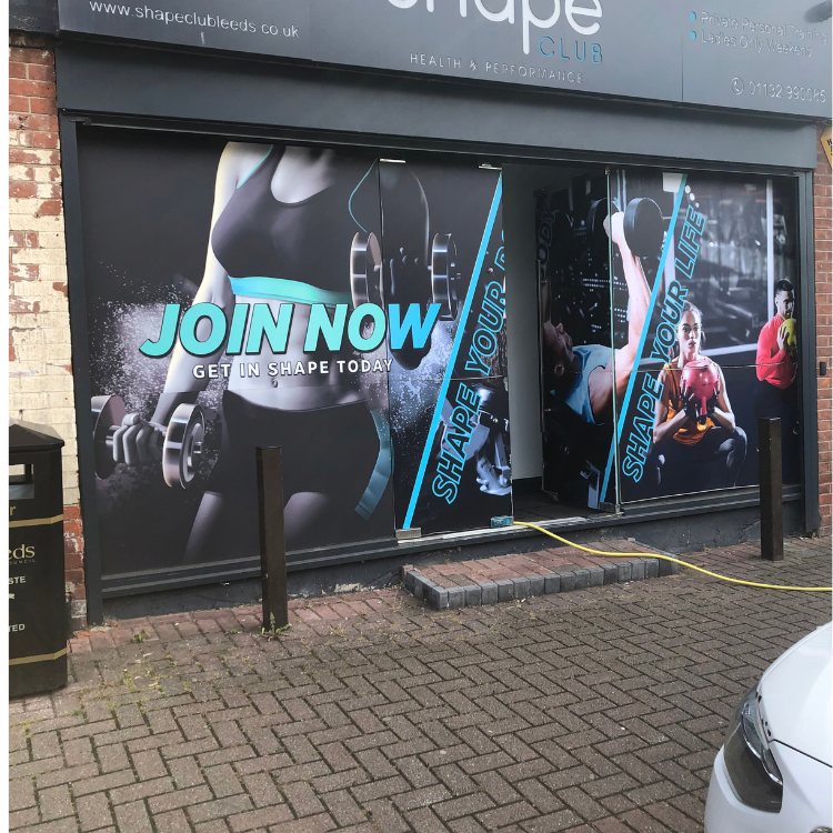 Block paved frontage of a gym before cleaning, grey and dull
