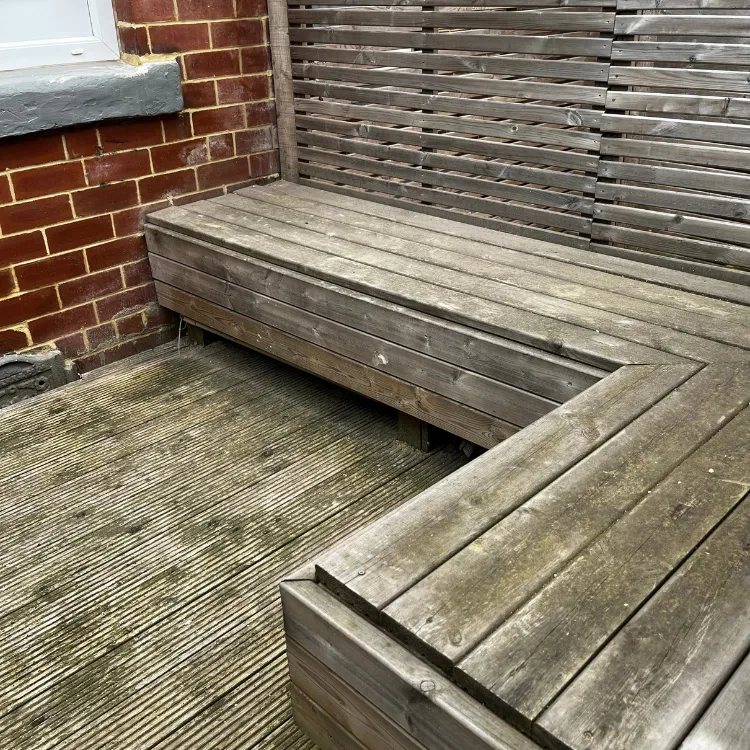 Decking and a built in bench in Roundhay before pressure washing, grey with algae