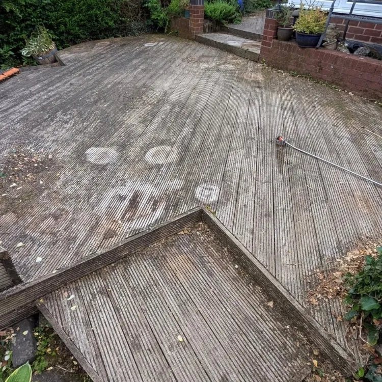 Stepped timber decking before cleaning, grey with algae