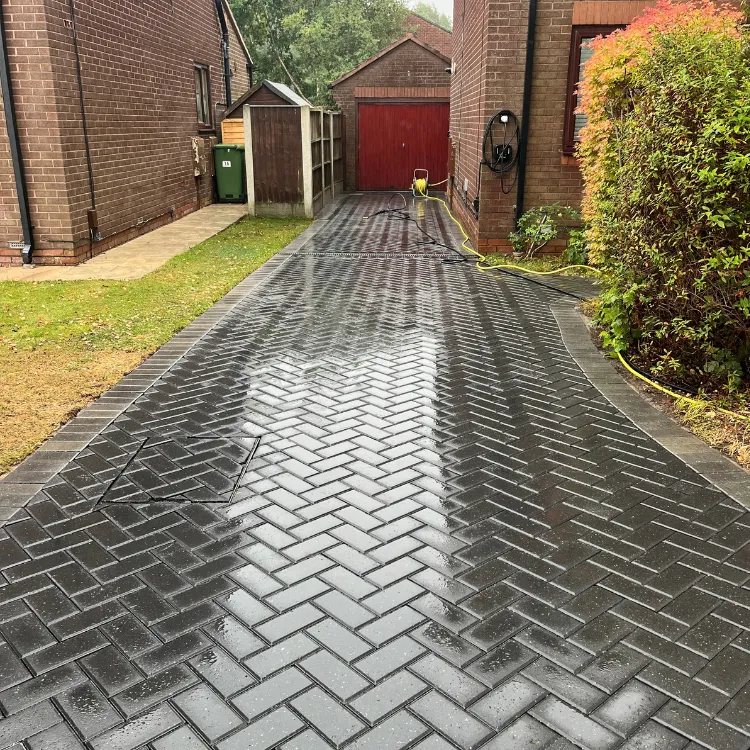 Charcoal block paved driveway in Shadwell after cleaning