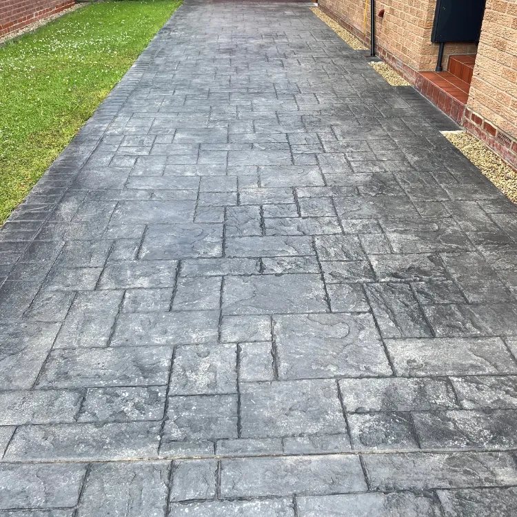 Pattern imprinted concrete driveway in Garforth before sealing, dull and grey
