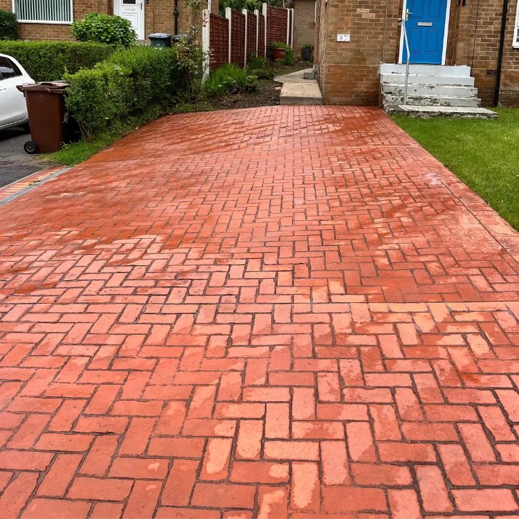 The same driveway after pressure washing, still wet