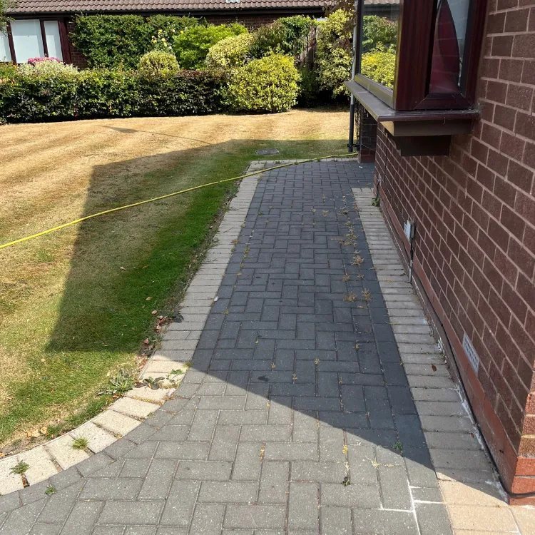 Block paved path beside a house in Shadwell before pressure washing