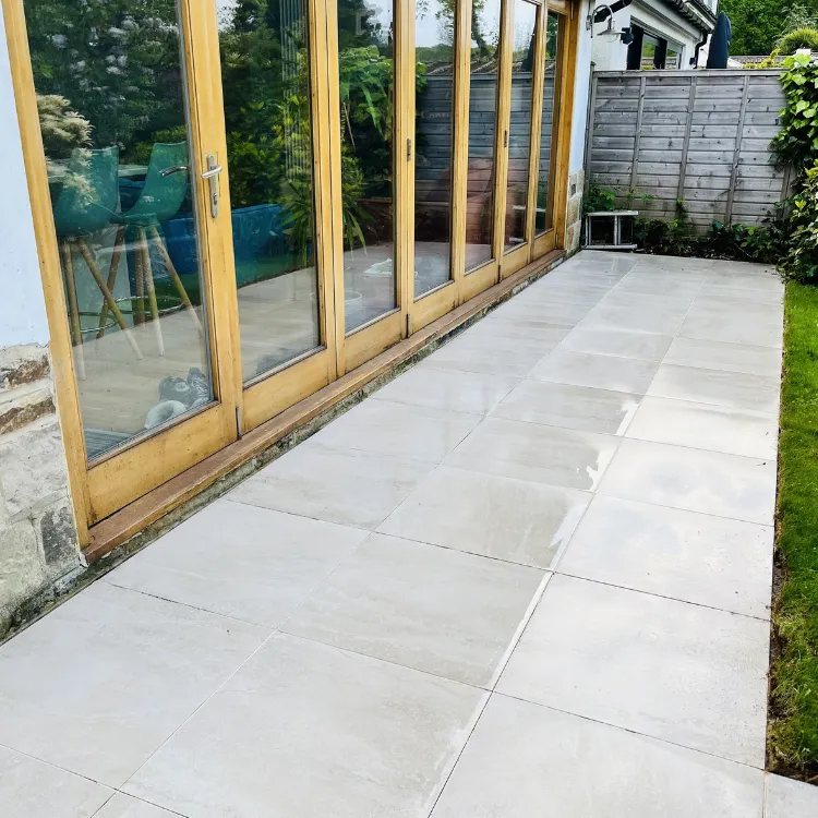 The same tiled patio after pressure washing, seen from the other end