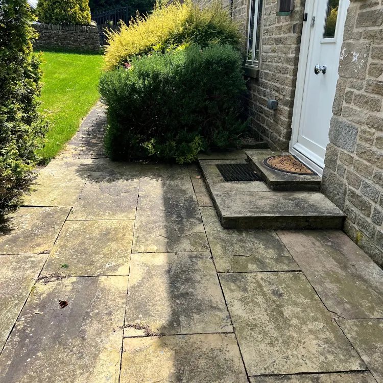 Indian sandstone path and steps before pressure washing, dark and stained