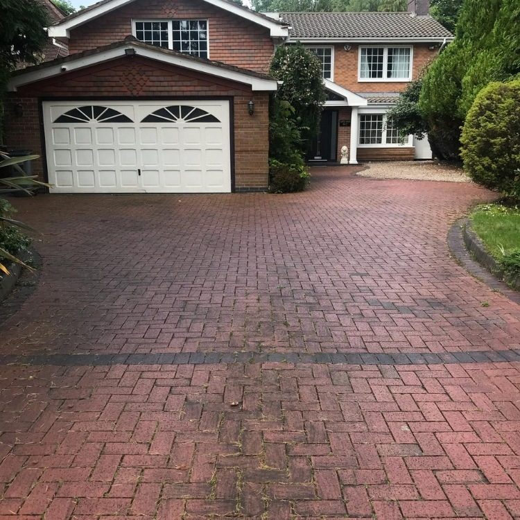 Block paved driveway in Leeds before pressure washing, dull and stained