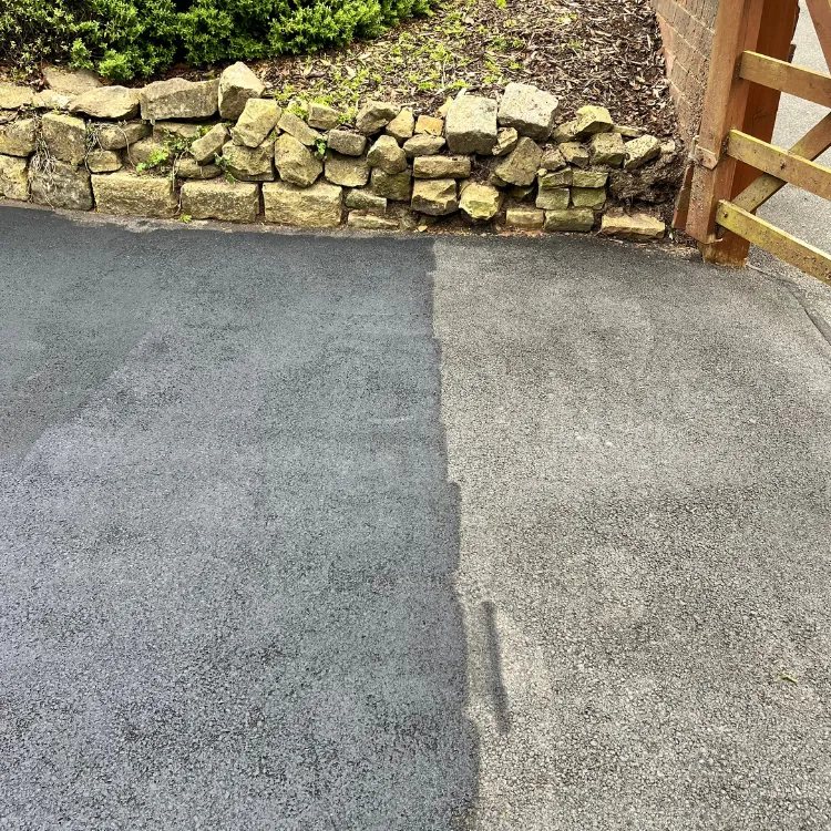 Tarmac driveway half coated, the new black finish beside the faded grey