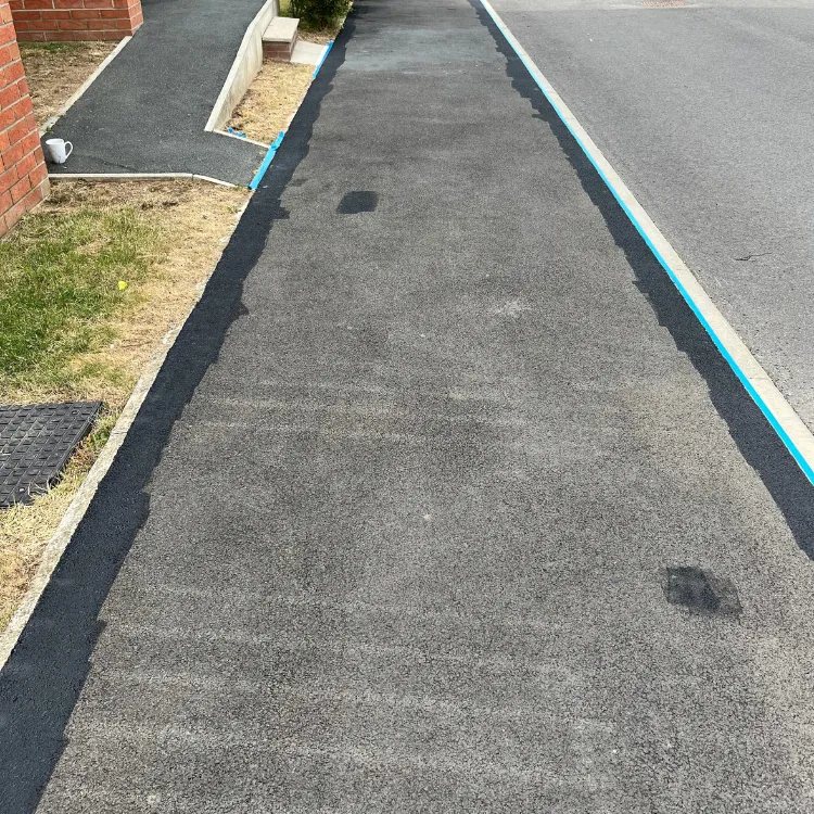 Tarmac footpath with the edges coated first, before the middle is filled in